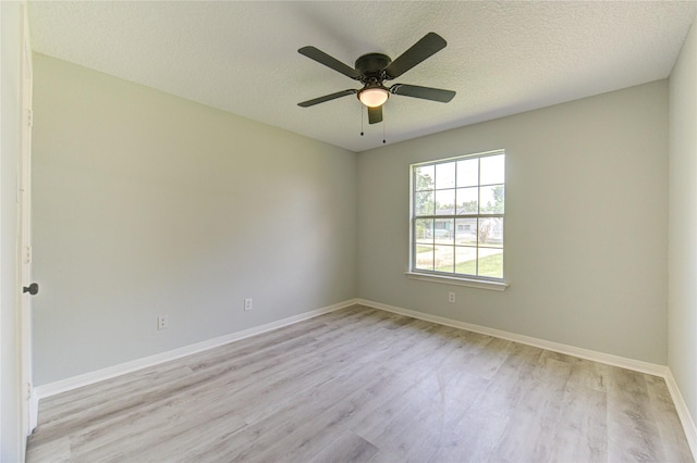 1221 Delores St, Kemah, TX 77565 - empty room with light wood-style flooring, a ceiling fan, and a textured ceiling