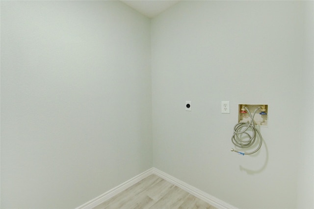 1221 Delores St, Kemah, TX 77565 - laundry area featuring electric dryer hookup, washer hookup, and light wood finished floors