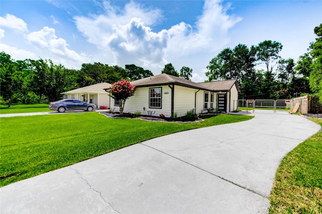 1221 Delores St, Kemah, TX 77565 - ranch-style home featuring driveway and a gate