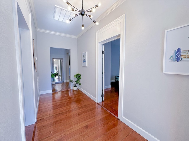 3128 Avenue N, Galveston, TX 77550 - hall with crown molding, a chandelier, and light wood-type flooring