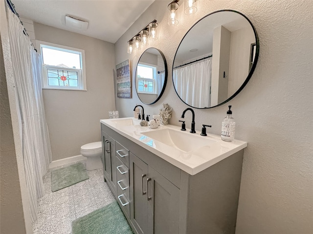3128 Avenue N, Galveston, TX 77550 - bathroom featuring double vanity, a textured wall, and granite floors