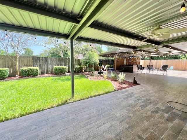 8009 Dellanera Dr, Hitchcock, TX 77563 - fenced backyard with a hot tub, a ceiling fan, and a patio