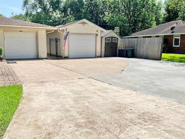 8009 Dellanera Dr, Hitchcock, TX 77563 - view of home's exterior featuring concrete driveway, a storage shed, and a garage