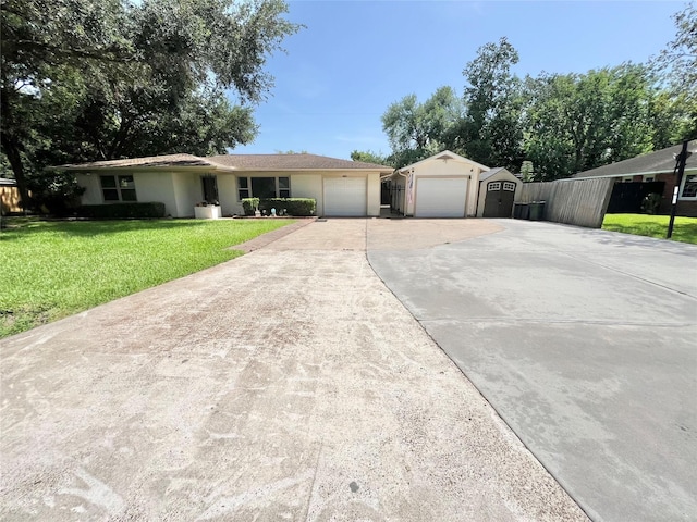 8009 Dellanera Dr, Hitchcock, TX 77563 - ranch-style house featuring a garage, concrete driveway, a front yard, a storage shed, and stucco siding