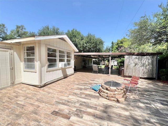8009 Dellanera Dr, Hitchcock, TX 77563 - wooden deck with an outdoor fire pit, a patio area, a storage shed, and cooling unit