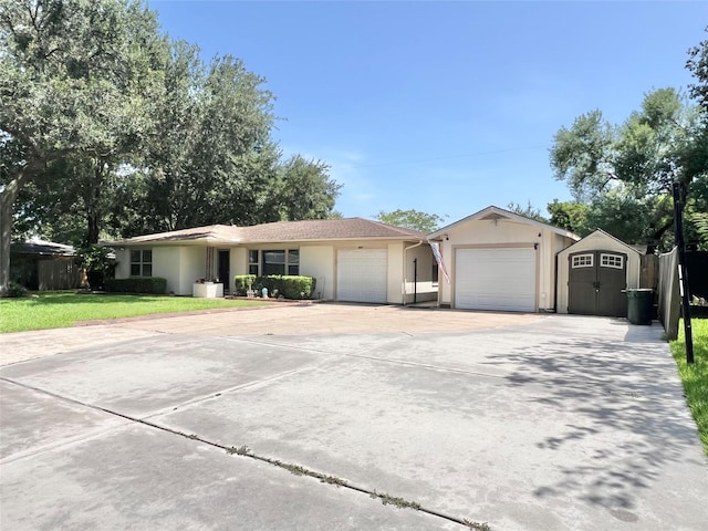 8009 Dellanera Dr, Hitchcock, TX 77563 - single story home featuring a garage, concrete driveway, a storage unit, stucco siding, and a front lawn