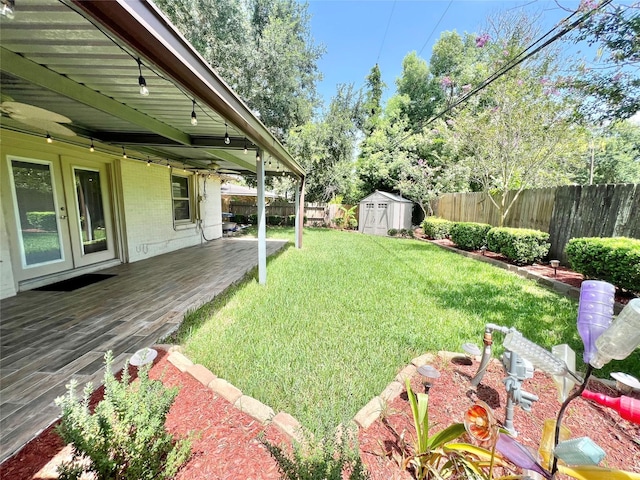 8009 Dellanera Dr, Hitchcock, TX 77563 - fenced backyard with french doors, a shed, and a wooden deck