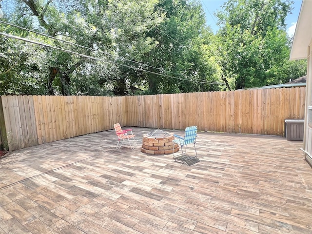8009 Dellanera Dr, Hitchcock, TX 77563 - fenced backyard with an outdoor fire pit and a patio area