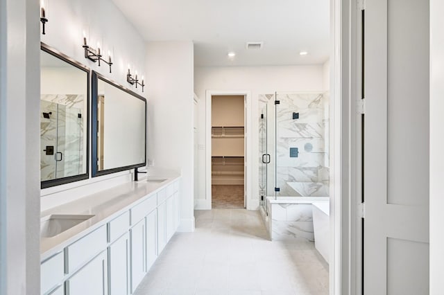 12008 Royal Oaks Banner Way, Houston, TX 77082 - full bath with a marble finish shower, a tub to relax in, double vanity, a walk in closet, and recessed lighting