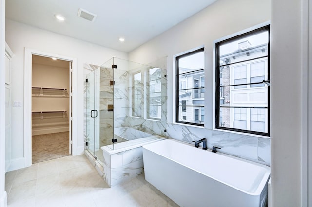 12008 Royal Oaks Banner Way, Houston, TX 77082 - full bathroom with a freestanding tub, a marble finish shower, a spacious closet, and recessed lighting