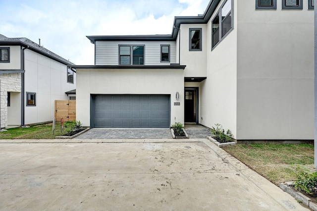 12008 Royal Oaks Banner Way, Houston, TX 77082 - modern home with stucco siding, a garage, and driveway