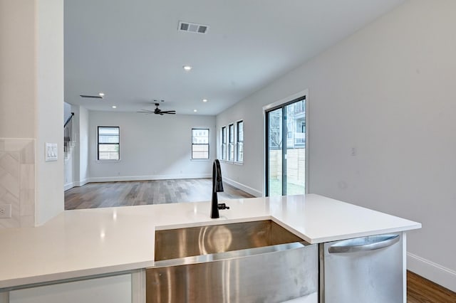 12008 Royal Oaks Banner Way, Houston, TX 77082 - kitchen featuring dishwasher, light countertops, wood finished floors, ceiling fan, and open floor plan