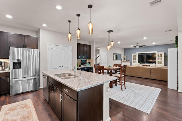 1942 Elkington Cir, Conroe, TX 77304 - kitchen featuring appliances with stainless steel finishes, dark brown cabinets, dark wood-type flooring, and recessed lighting