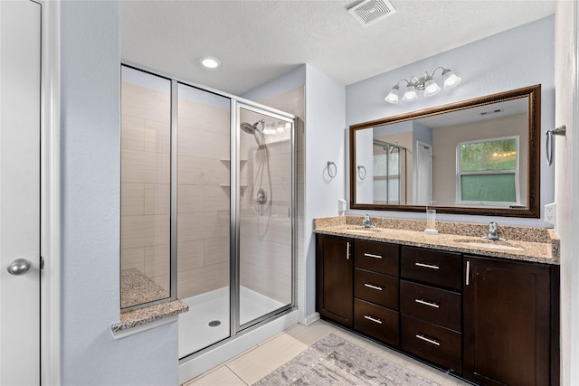 1942 Elkington Cir, Conroe, TX 77304 - full bath with a stall shower, double vanity, a textured ceiling, and tile patterned flooring