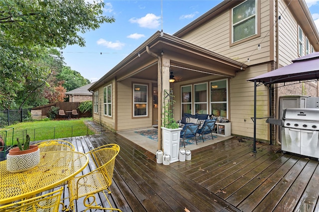 1942 Elkington Cir, Conroe, TX 77304 - wooden terrace featuring area for grilling, a fenced backyard, a gazebo, a ceiling fan, and outdoor dining space