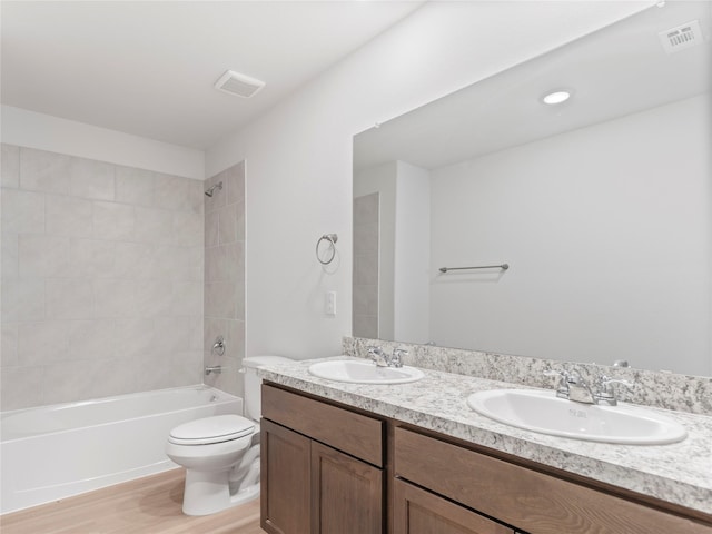 304 N Orange St, Sweeny, TX 77480 - full bathroom with double vanity, wood finished floors, and shower / bathtub combination