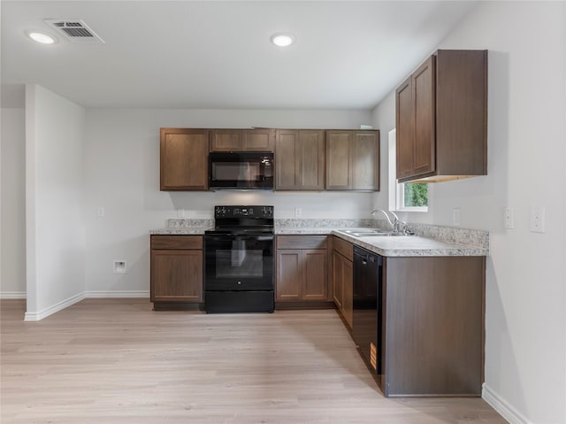 304 N Orange St, Sweeny, TX 77480 - kitchen featuring black appliances, light countertops, light wood finished floors, and recessed lighting
