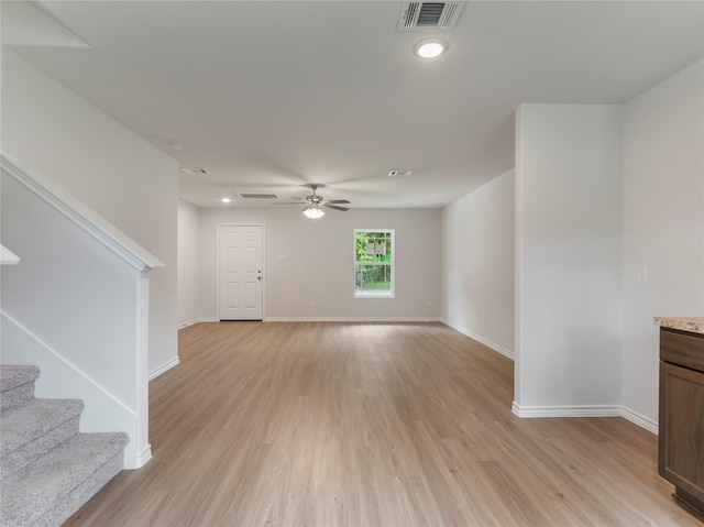 304 N Orange St, Sweeny, TX 77480 - unfurnished living room with light wood-style flooring, a ceiling fan, and stairway