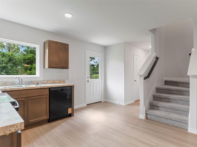 304 N Orange St, Sweeny, TX 77480 - kitchen with black dishwasher, light countertops, light wood-style flooring, brown cabinetry, and recessed lighting