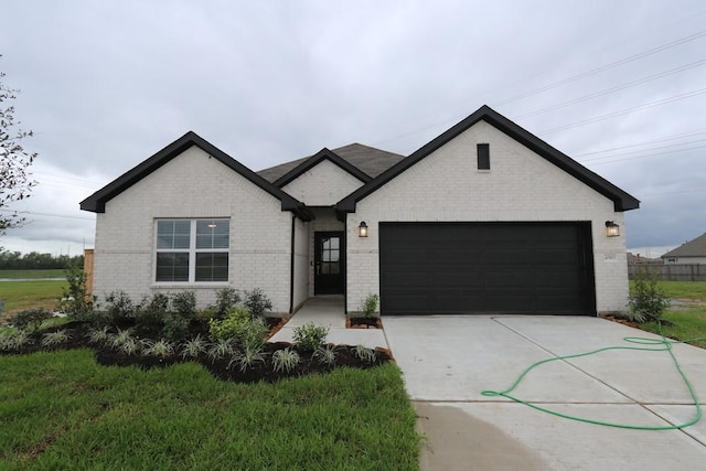 4989 Perennial Ln, La Marque, TX 77568 - view of front of house featuring brick siding, a garage, and concrete driveway