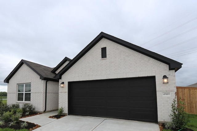 4989 Perennial Ln, La Marque, TX 77568 - view of front facade featuring brick siding, driveway, and a garage