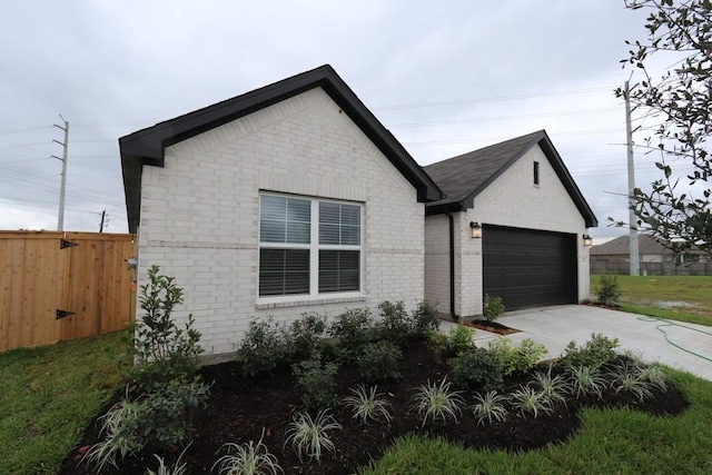 4989 Perennial Ln, La Marque, TX 77568 - view of side of property featuring a garage, driveway, and brick siding