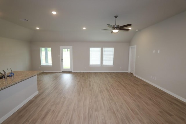 4989 Perennial Ln, La Marque, TX 77568 - unfurnished living room featuring vaulted ceiling, a ceiling fan, wood finished floors, and recessed lighting