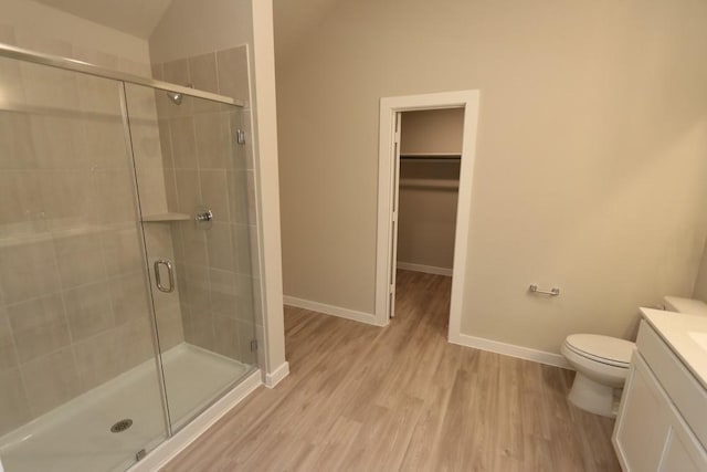 4989 Perennial Ln, La Marque, TX 77568 - full bath with vanity, a shower stall, wood finished floors, vaulted ceiling, and a walk in closet