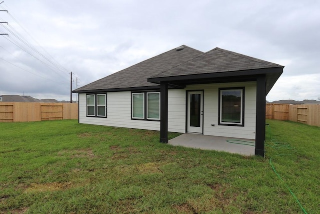 4989 Perennial Ln, La Marque, TX 77568 - rear view of property with a shingled roof, a fenced backyard, and a patio