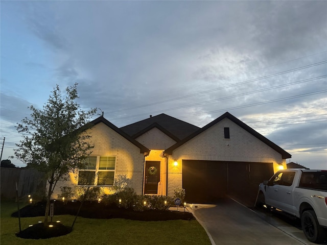 4989 Perennial Ln, La Marque, TX 77568 - view of front facade with brick siding, driveway, a garage, and a front lawn