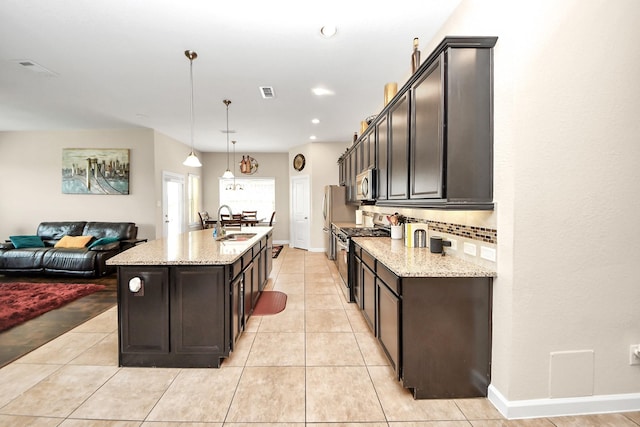 9430 Jayci Hills Ln, Cypress, TX 77433 - kitchen with stainless steel appliances, decorative backsplash, open floor plan, light stone countertops, and recessed lighting