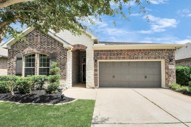 9430 Jayci Hills Ln, Cypress, TX 77433 - view of front of home with brick siding, driveway, an attached garage, roof with shingles, and stone siding