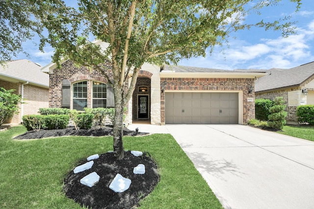 9430 Jayci Hills Ln, Cypress, TX 77433 - view of front of home featuring brick siding, an attached garage, a front lawn, and driveway