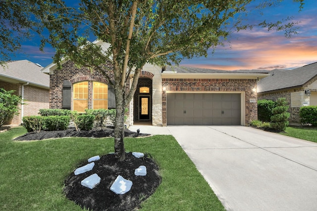 9430 Jayci Hills Ln, Cypress, TX 77433 - view of front of property with brick siding, a garage, driveway, and a front yard