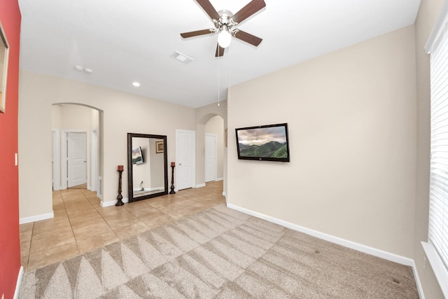 9430 Jayci Hills Ln, Cypress, TX 77433 - empty room with arched walkways, a ceiling fan, light carpet, light tile patterned flooring, and recessed lighting