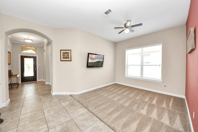 9430 Jayci Hills Ln, Cypress, TX 77433 - entrance foyer featuring arched walkways, a ceiling fan, and light tile patterned flooring
