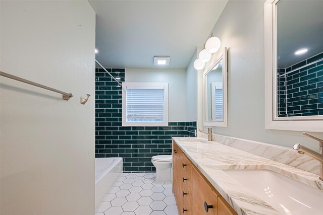 6206 San Felipe St, Houston, TX 77057 - full bathroom with tile patterned floors, double vanity, tile walls,  shower combination, and a wainscoted wall