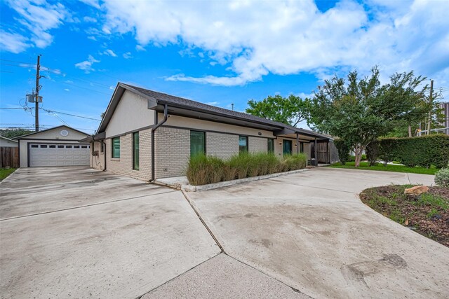 6206 San Felipe St, Houston, TX 77057 - view of front of property with brick siding, an outdoor structure, and a detached garage