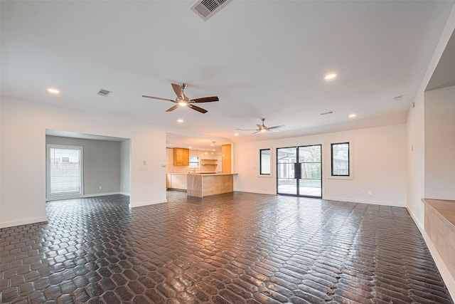 6206 San Felipe St, Houston, TX 77057 - unfurnished living room with a ceiling fan, healthy amount of natural light, recessed lighting, and dark stone finish floors