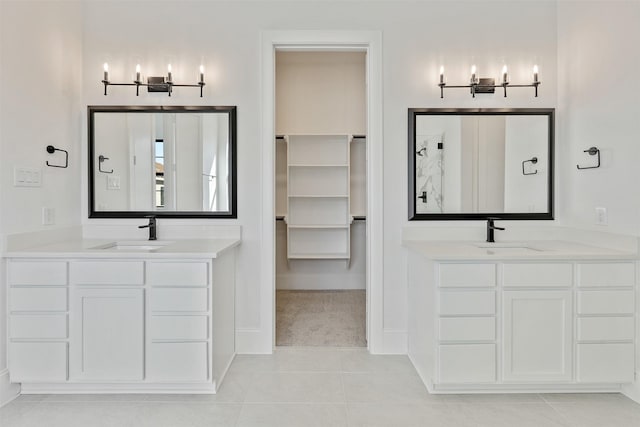 3223 Royal Oaks Hollow Ln, Houston, TX 77082 - bathroom with a chandelier, two vanities, tile patterned flooring, and a spacious closet