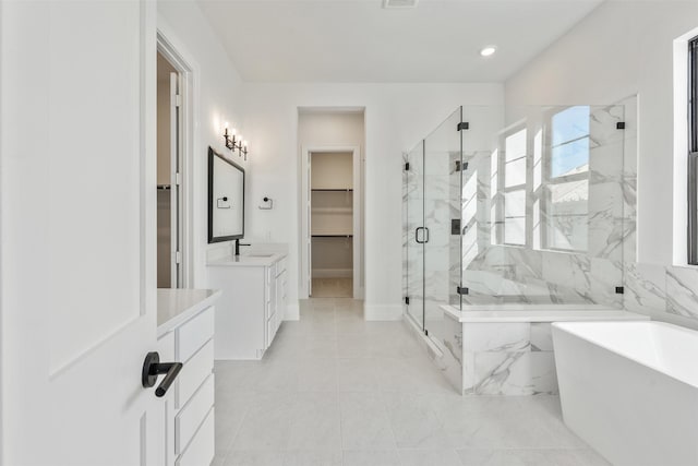 3223 Royal Oaks Hollow Ln, Houston, TX 77082 - bathroom with vanity, a marble finish shower, a soaking tub, a spacious closet, and recessed lighting
