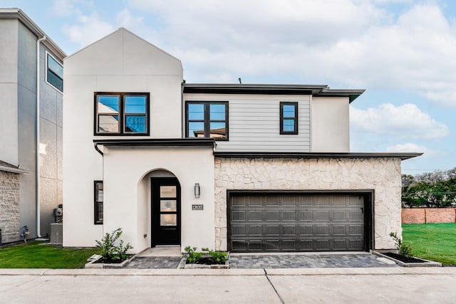 3223 Royal Oaks Hollow Ln, Houston, TX 77082 - view of front facade featuring a garage, driveway, stucco siding, and stone siding