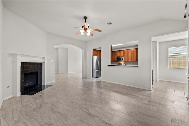 621 Rocky Hollow Ln, League City, TX 77573 - unfurnished living room with ceiling fan, arched walkways, and a tile fireplace