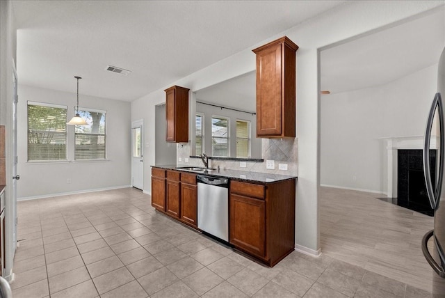 621 Rocky Hollow Ln, League City, TX 77573 - kitchen featuring stainless steel appliances, light tile patterned floors, tasteful backsplash, and a fireplace with flush hearth