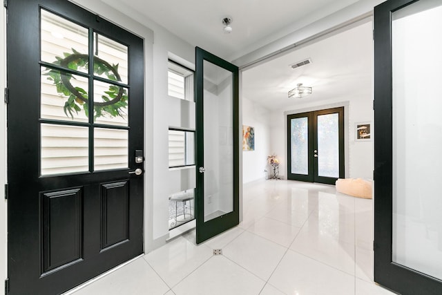 1807 Dart St, Houston, TX 77007 - foyer entrance featuring french doors, light tile patterned floors, and healthy amount of natural light