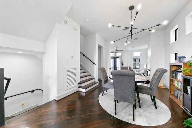 1807 Dart St, Houston, TX 77007 - dining space featuring wood finished floors, stairs, and a chandelier