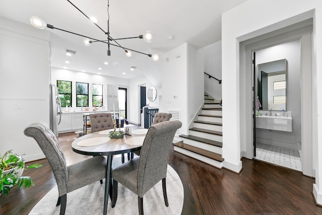 1807 Dart St, Houston, TX 77007 - dining area with dark wood-type flooring, stairway, and a chandelier