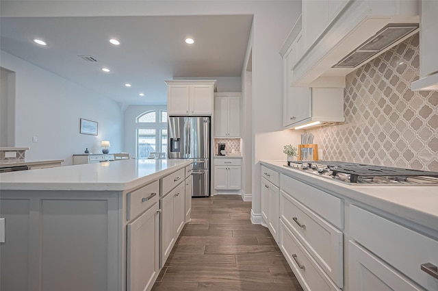 2430 Sunflower Cove Ln, Brookshire, TX 77423 - kitchen featuring appliances with stainless steel finishes, recessed lighting, light countertops, custom range hood, and white cabinetry