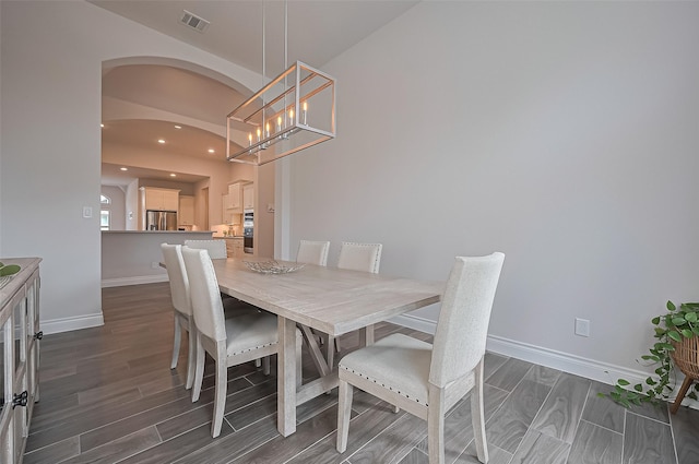 2430 Sunflower Cove Ln, Brookshire, TX 77423 - dining space with wood tiled floors, recessed lighting, a chandelier, and arched walkways