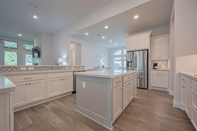 2430 Sunflower Cove Ln, Brookshire, TX 77423 - kitchen featuring appliances with stainless steel finishes, a center island, recessed lighting, tasteful backsplash, and white cabinetry